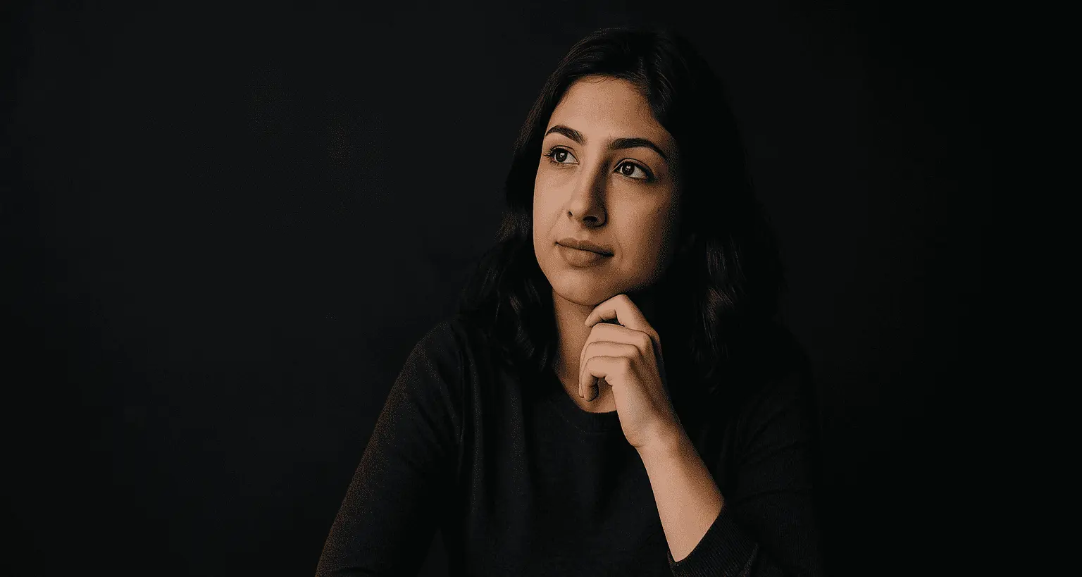 A woman thinking about how to answer what motivates you in an interview